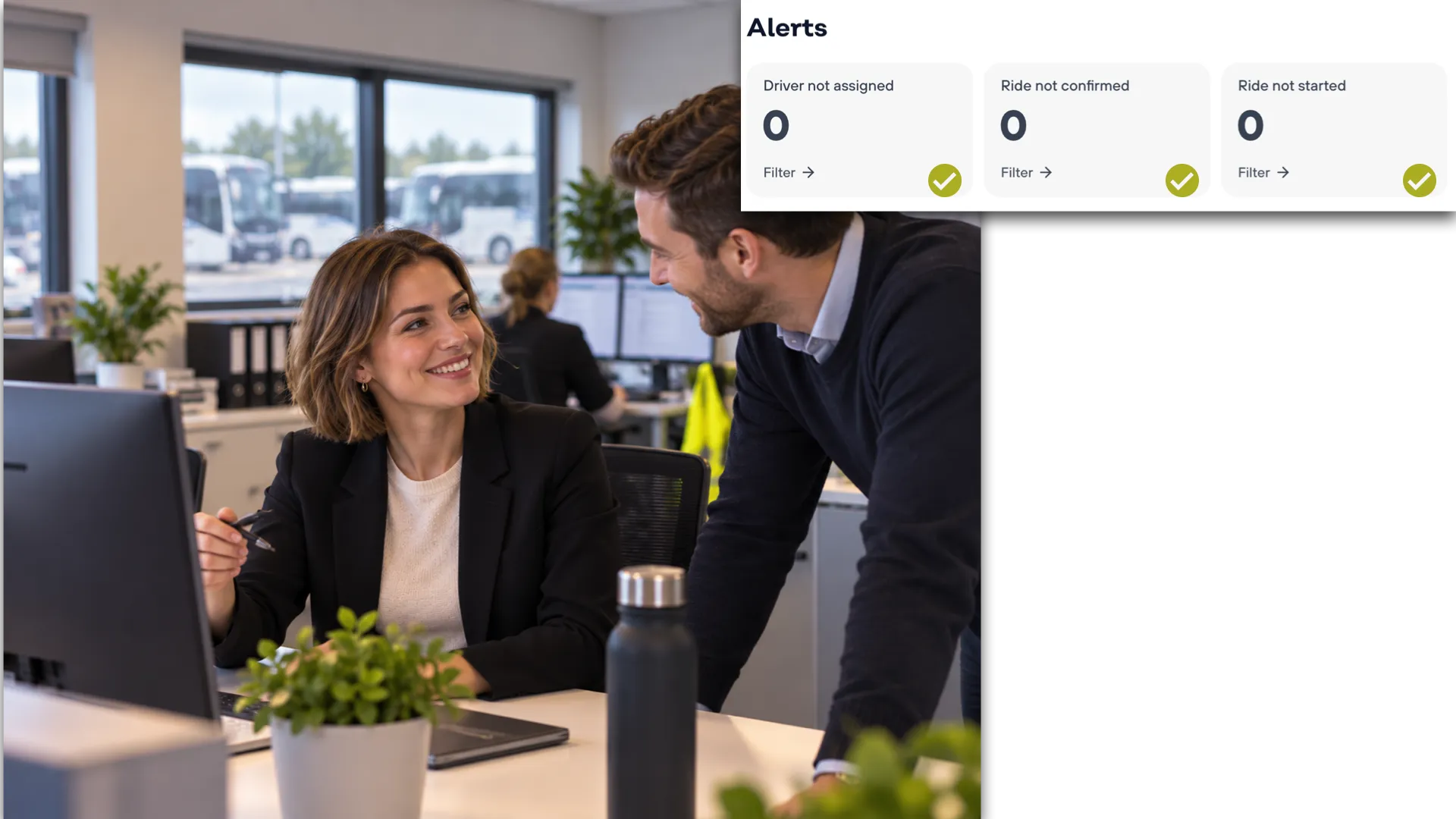 Two colleagues talking at a desk in a coach operator's office, the fleet parked outside the window behind them, beside a Mobifer alerts panel showing zero for driver not assigned, ride not confirmed and ride not started